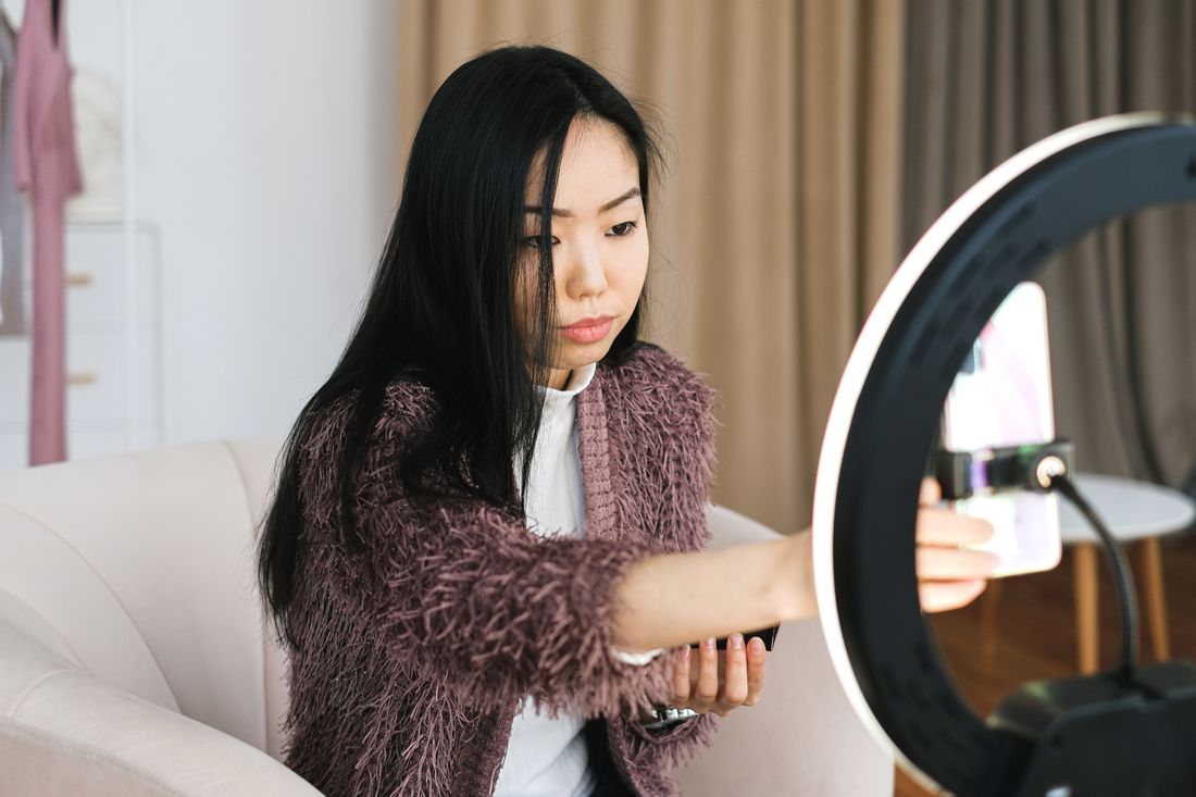 A creator setting up a ring light to record